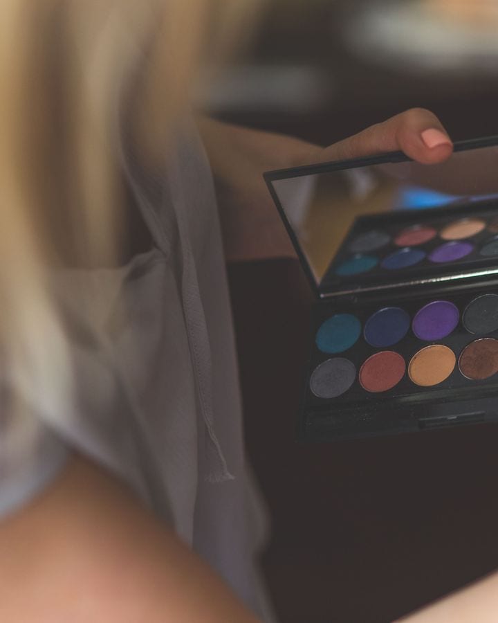 An open eyeshadow palette held up to the light